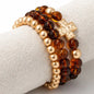 BROWN AND GOLD W CROSS BRACELET