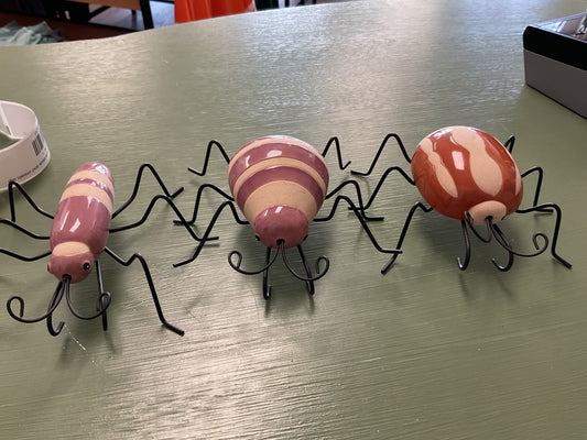 Plant bugs hang on side of pots