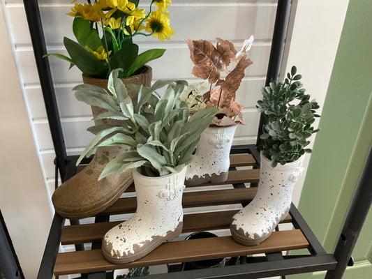 Small white boots with greenery and flowers