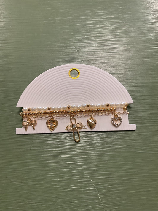 Triple charm bracelet, pearl, gold, and chain w/ bow, hearts, cross