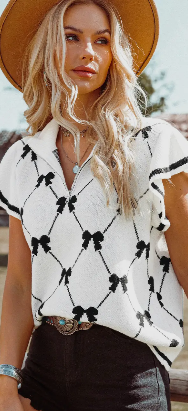 Cream and black bow sweater vest