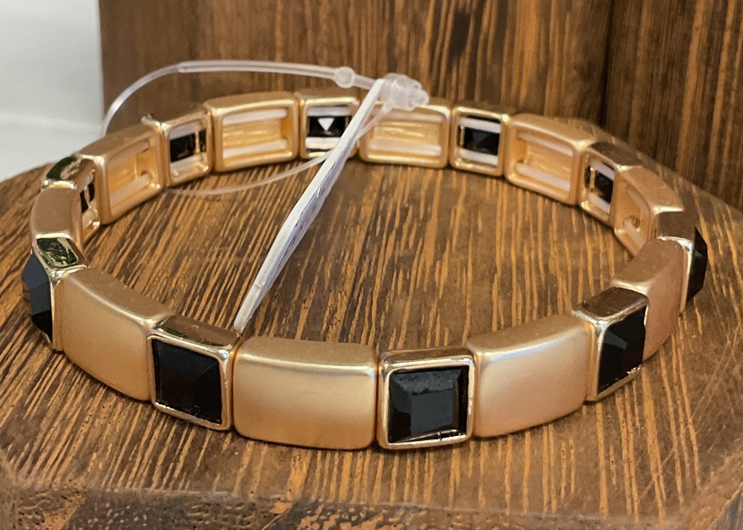 Gold stretch bracelet with black stones
