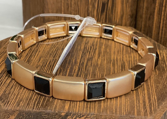 Gold stretch bracelet with black stones