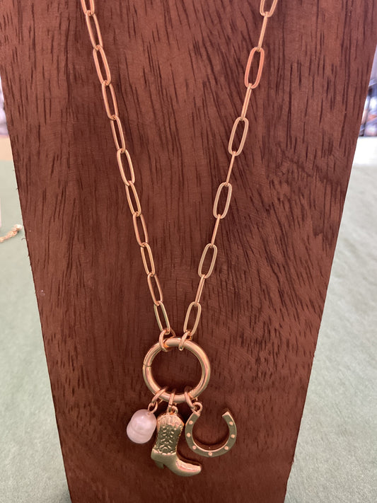 Gold charm necklace with cowboy boot and horseshoe and pearl