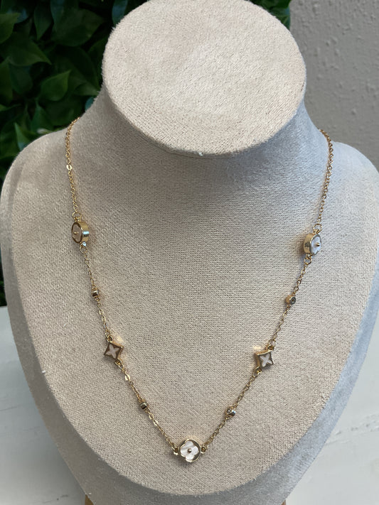 Gold necklace with white enamel charms