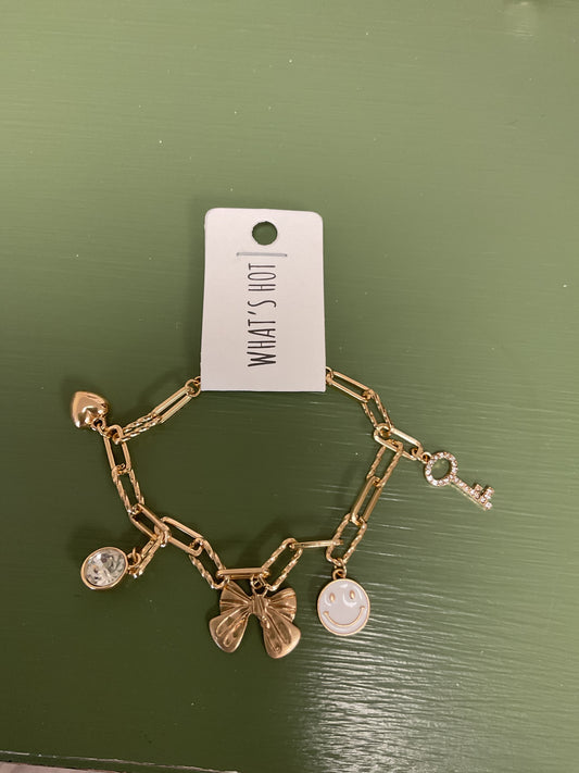 Gold charm bracelet with bow/face/key/heart/gem