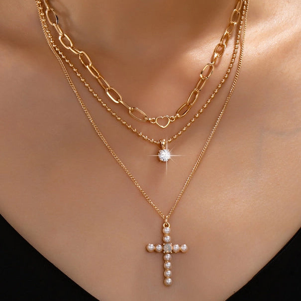 MULTI LAYERED GOLD CHAINS WITH PEARL CROSS